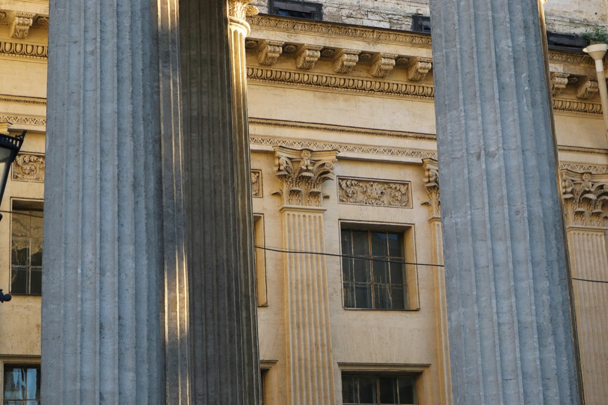 a building with columns and a street light in front of it