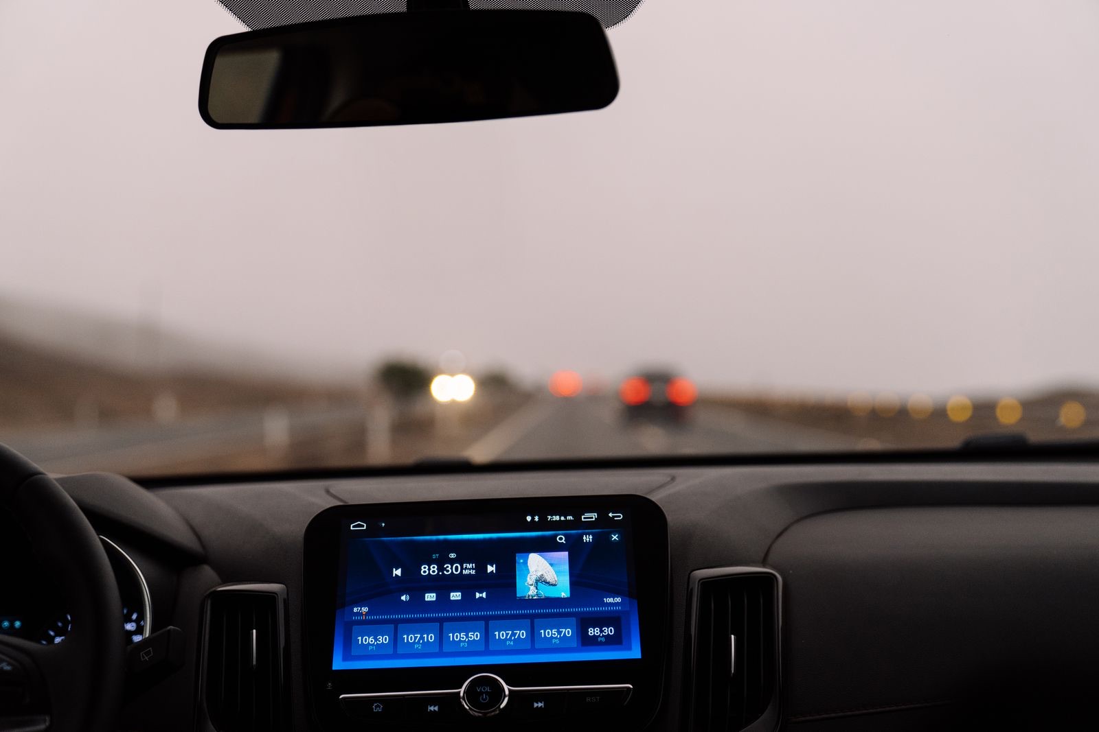 A car dashboard on an open road