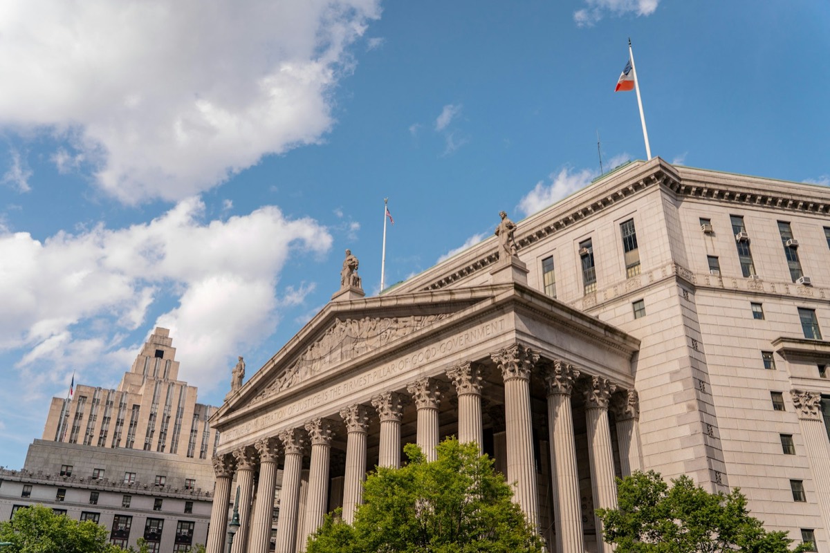 A classical-style courthouse stands under a blue sky