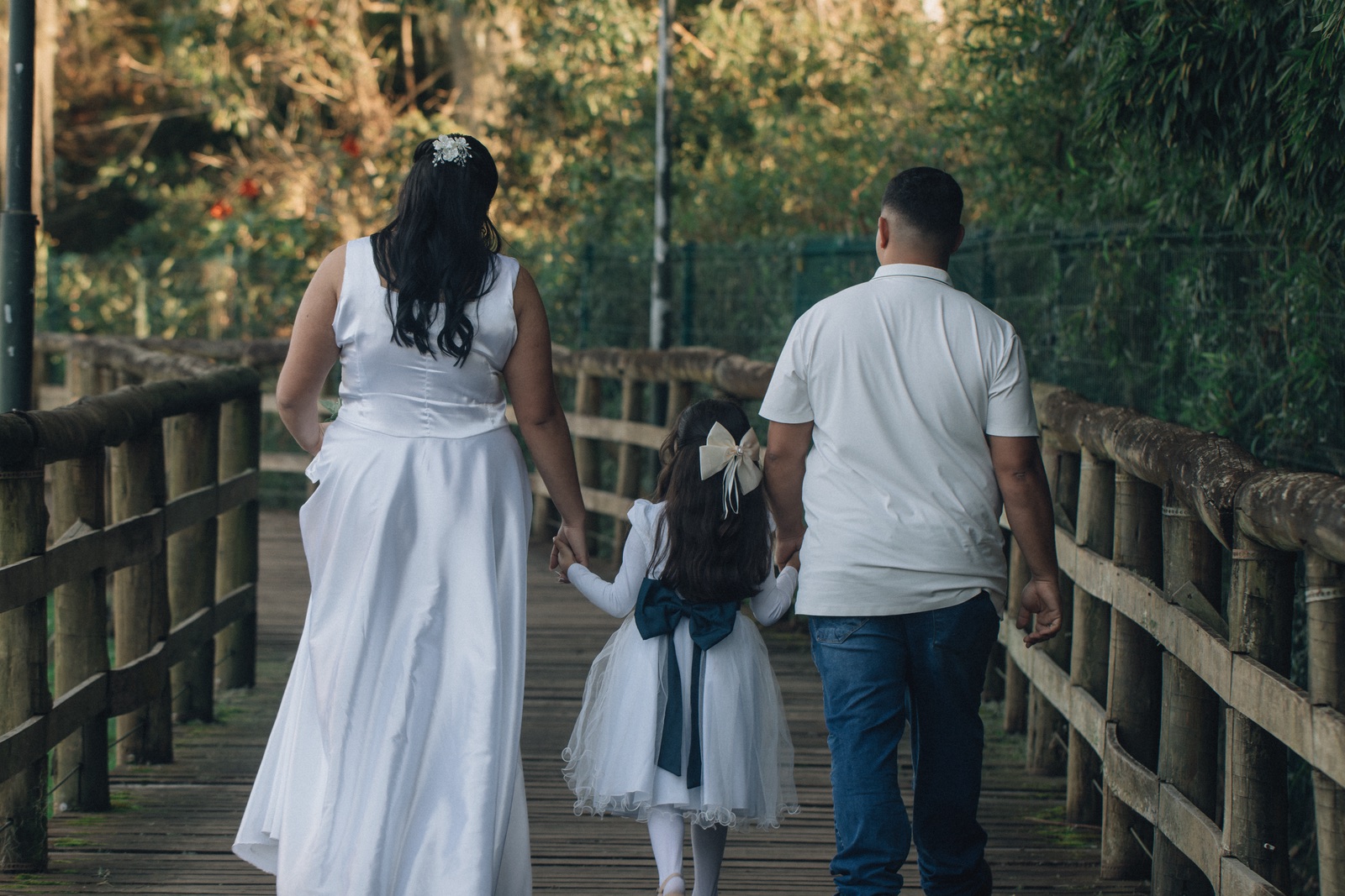 A family walking on a wooden bridge