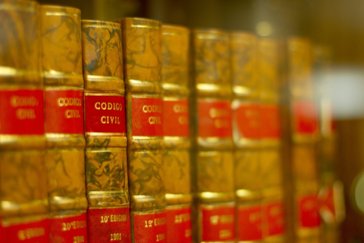 a row of red and yellow books on a shelf