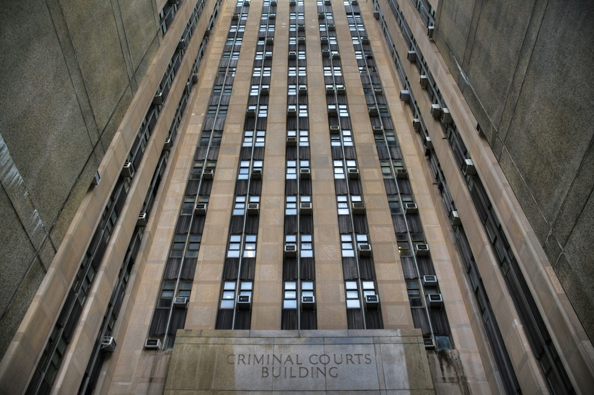 A tall building with windows and a sign on the side of it