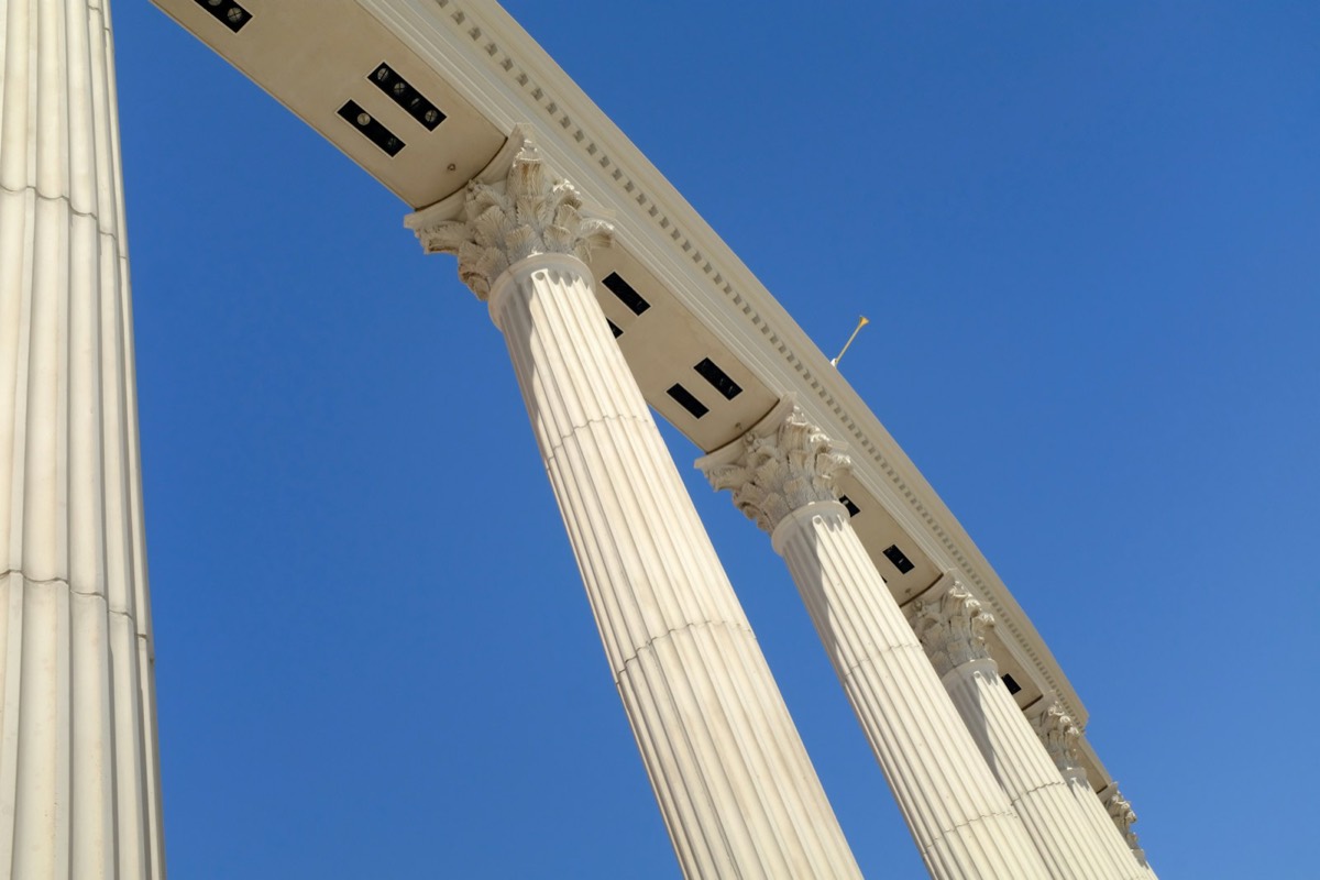 A tall white column with a clock on it's side