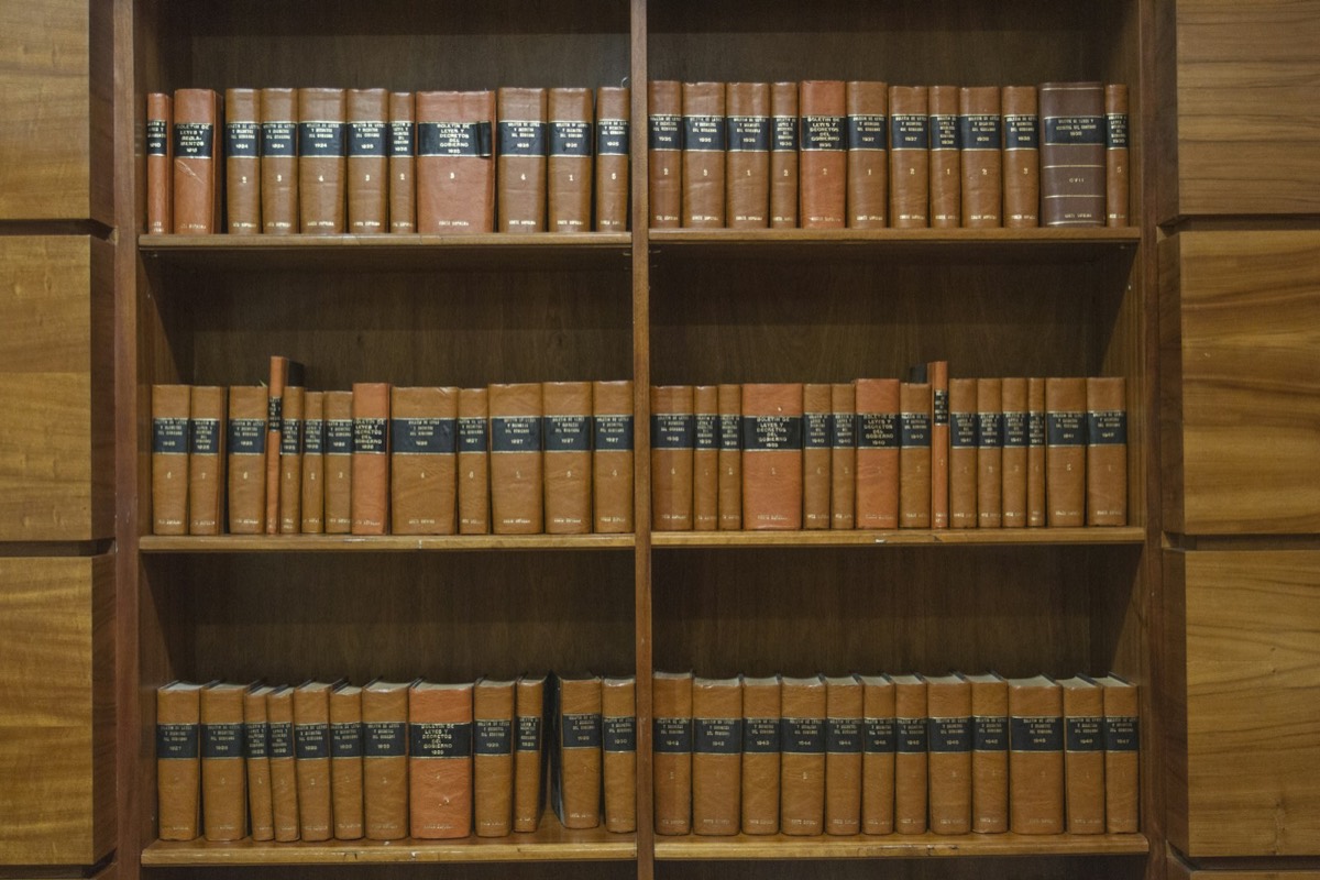 A wooden bookcase filled with lots of books