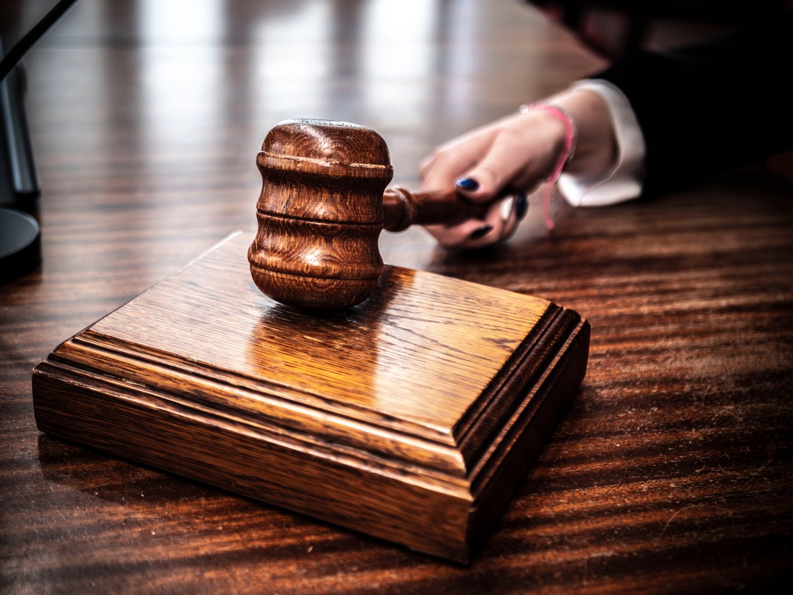 A wooden gavel on a judge's desk