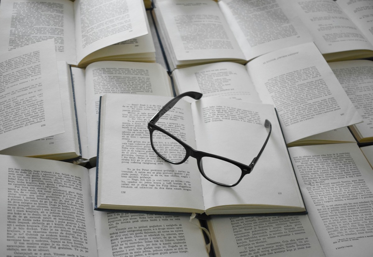 Black framed eyeglasses on white book page