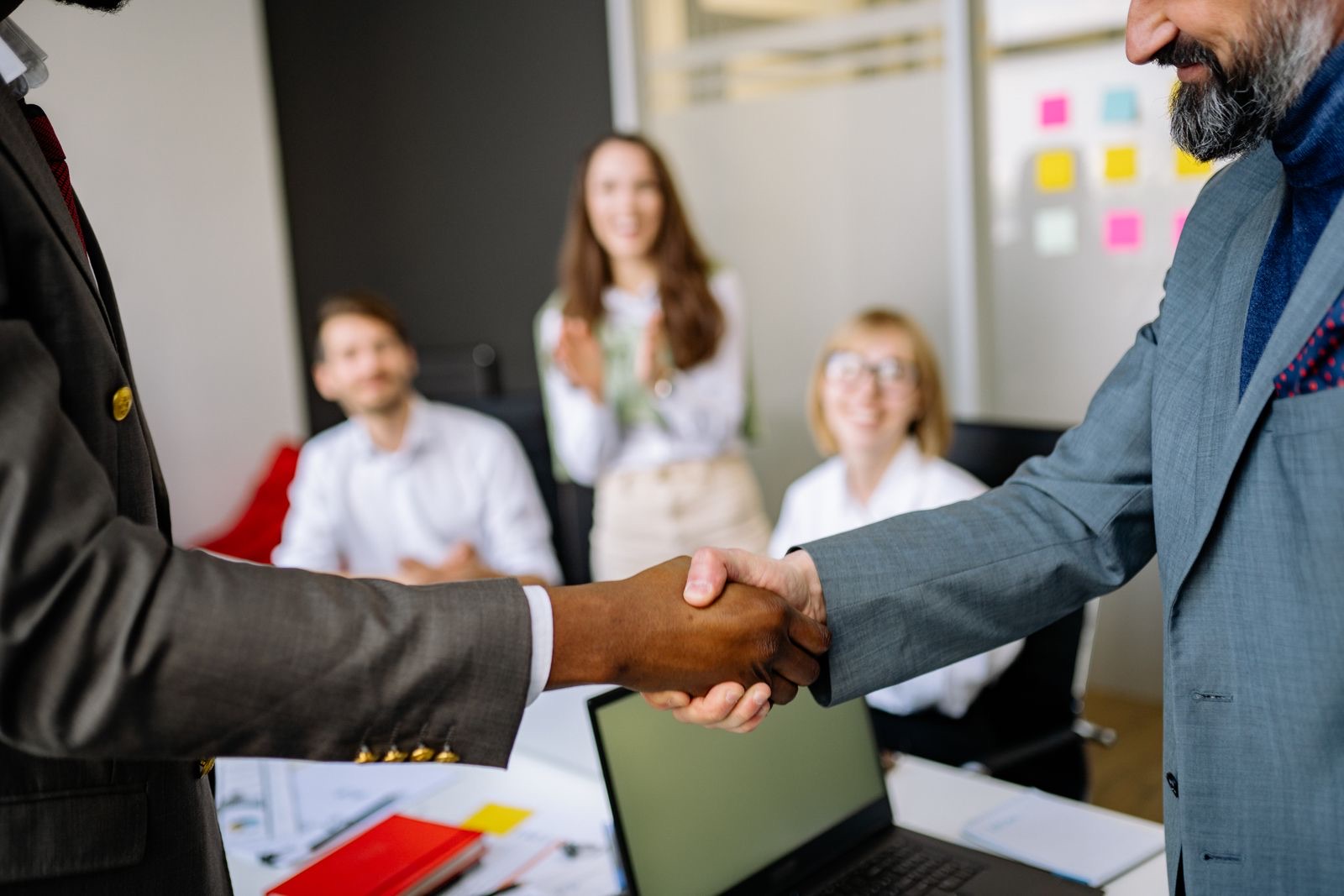 Colleagues shaking hands in an office