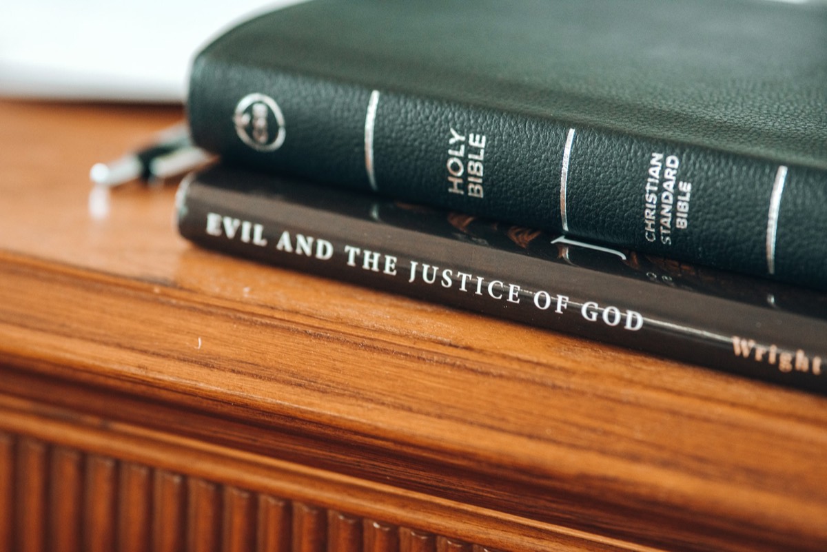 four books on brown wooden table