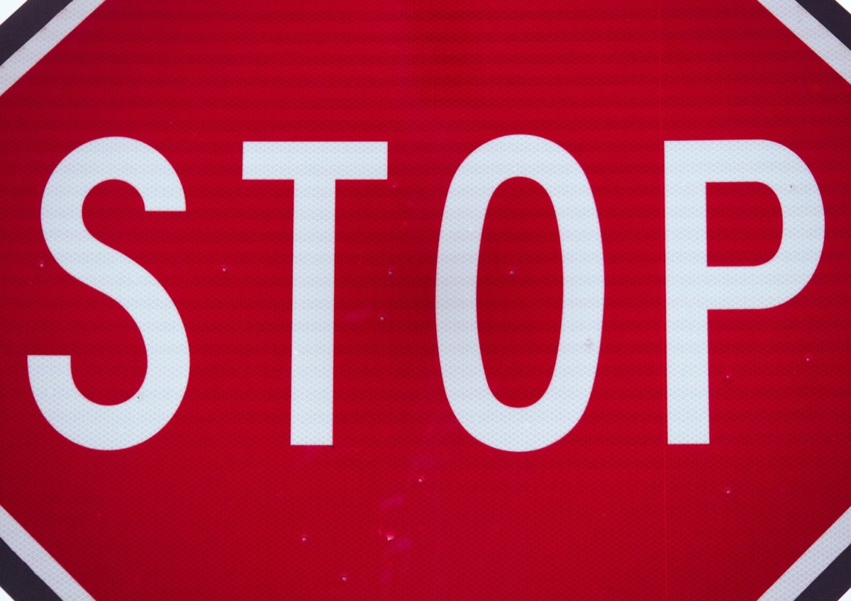 Red stop sign with white lettering