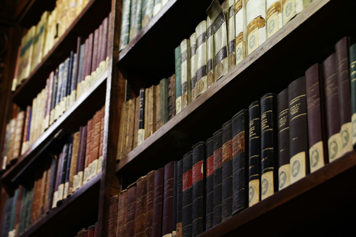 Rows of old books on library shelves