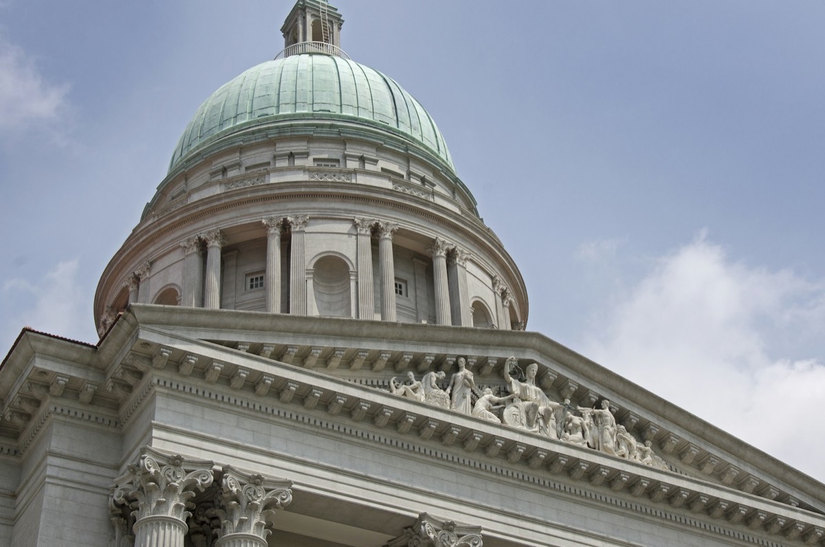 The dome of a building with statues on it